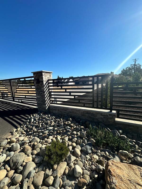 Sunlit wooden bridge over rocky landscape with blue sky