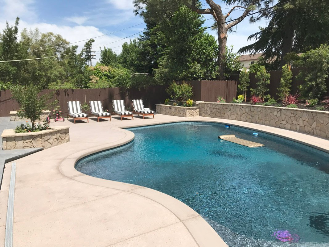 South Canyon Construction builds a relaxing backyard pool with lounge chairs