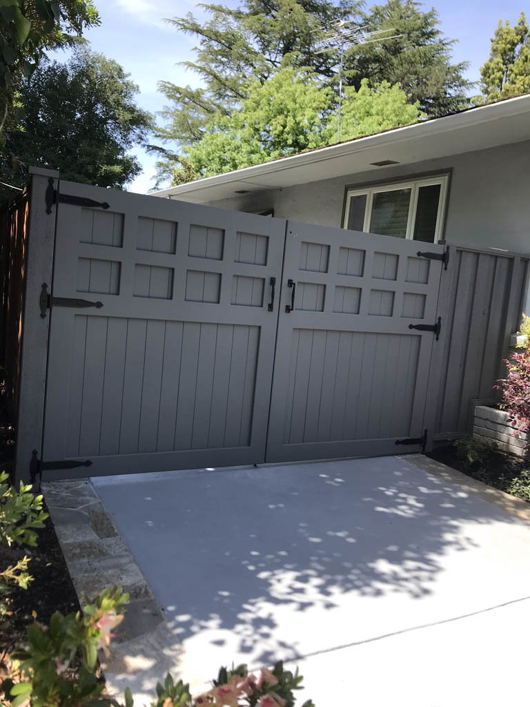 Gray double gate in front of a suburban home.