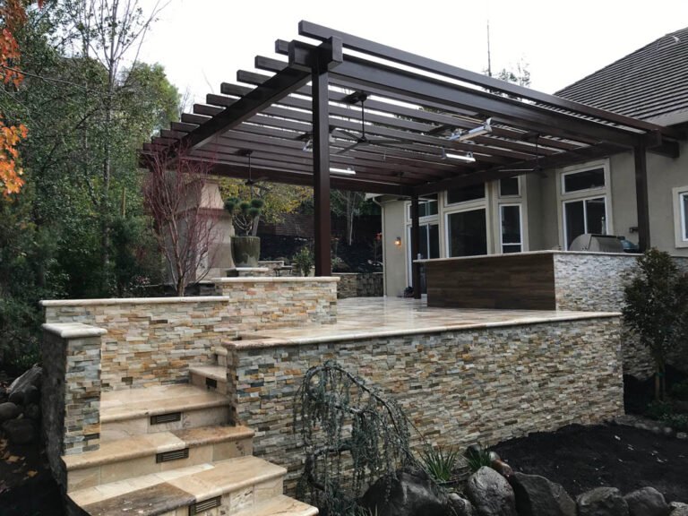 Elegant outdoor patio with pergola and stone steps.