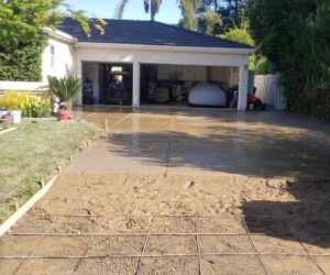 House driveway under concrete installation, suburban setting.