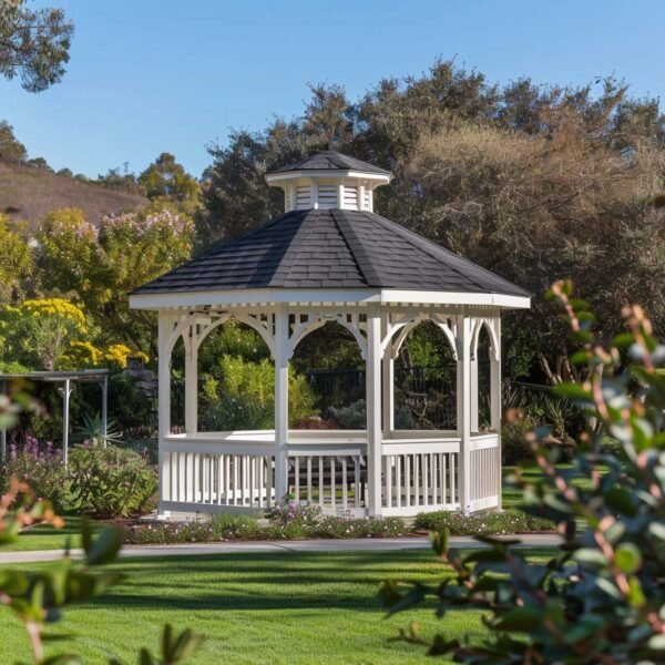 White garden gazebo surrounded by greenery under clear sky