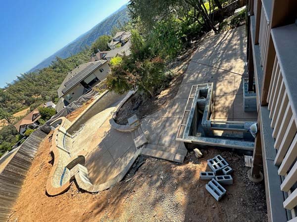 Aerial view of house construction site with unfinished pool