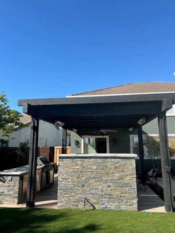 Outdoor patio with stone wall and pergola