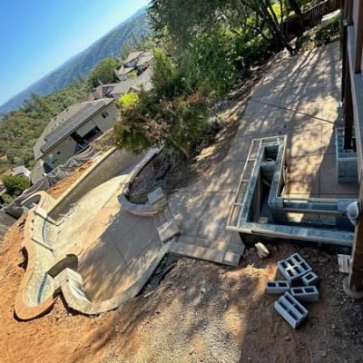 Aerial view of house construction site with unfinished pool