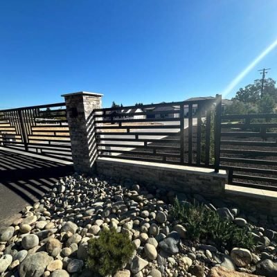 Sunlit wooden bridge over rocky landscape with blue sky