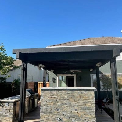 Outdoor patio with stone wall and pergola