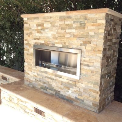 Outdoor stone fireplace with modern design.