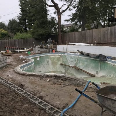 Backyard swimming pool under renovation.