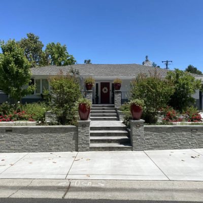 Suburban home with beautiful landscaping and stone steps.