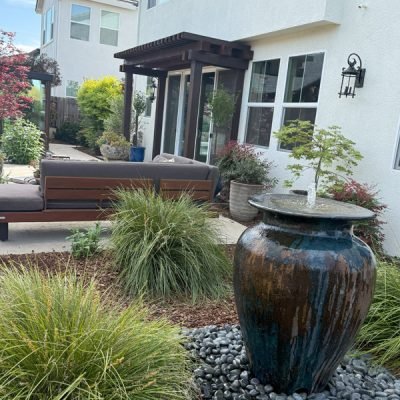 South Canyon Construction creates a modern outdoor space featuring a decorative fountain landscaping