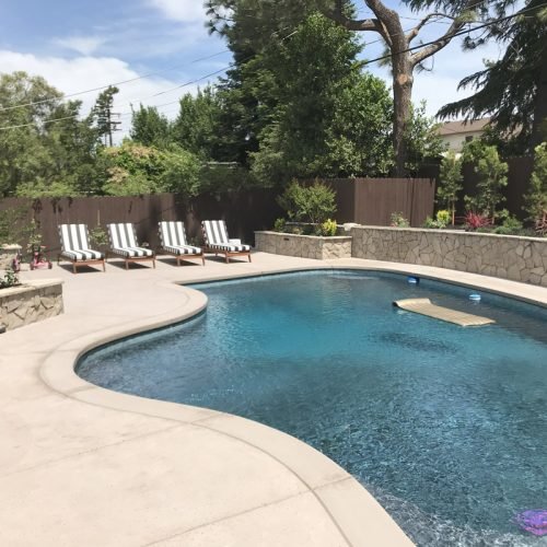South Canyon Construction builds a relaxing backyard pool with lounge chairs